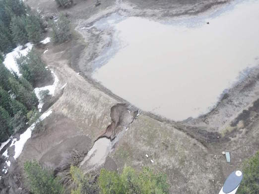 A Florida company will pay a fine and repair damage caused by the breach of its dam in southeast Washington state.