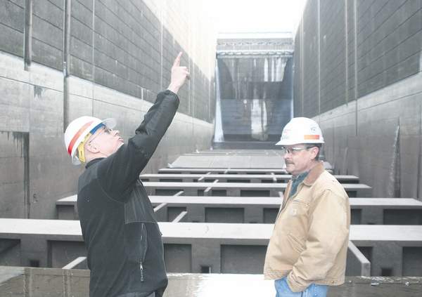 Steve Petrie, Oregon State University Columbia Basin Agricultural Research Center director, asks questions while standing in a 'dewatered' navigation lock with Little Goose Dam chief of maintenance Jim Simonsen March 14.