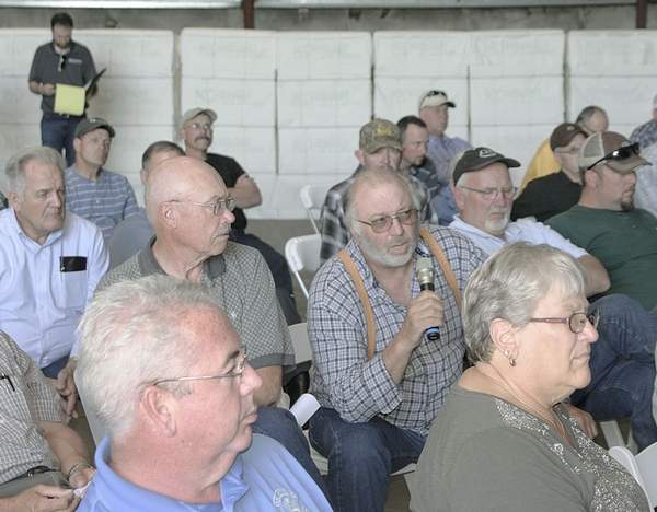 Matthew Weaver/Capital Press Gifford, Idaho, farmer Gene Butler, center, takes the microphone to ask a question of company representatives May 28 during an industry meeting at the Port of Lewiston, Idaho, to discuss transportation options following the loss of container carriers and labor issues at the Port of Portland.