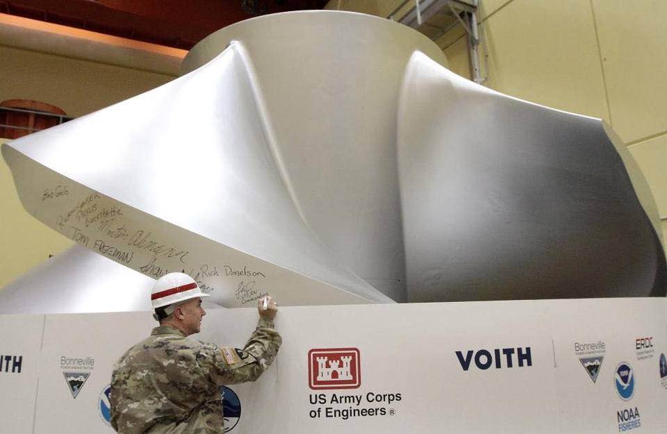 Lt. Col. Timothy Vail, commander of the Walla Walla District of the Army Corps of Engineers, adds his name to a list of signatures of key participants on a new high-tech turbine at Ice Harbor Dam on the Snake River near Burbank. The new fish friendly and higher-efficiency stainless steel turbine will be installed during a 14-month process. Watch a video at tricityherald.com. (Bob Brawdy photo)