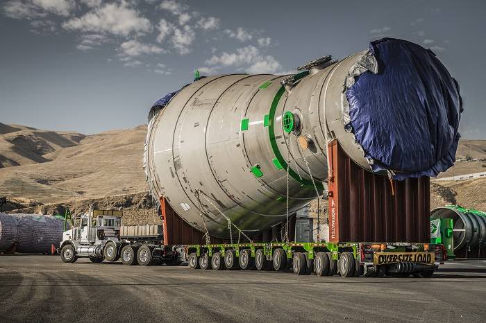 The year-old joint effort has produced a feasibility route study for moving mega-loads of up to 500 tons from Columbia River inland ports to Sweet Grass, Montana, the major port of entry into Canada. (Above: A large load being transported on a desert road.) Photo credit: High, Wide and Heavy Corridor Coalition.