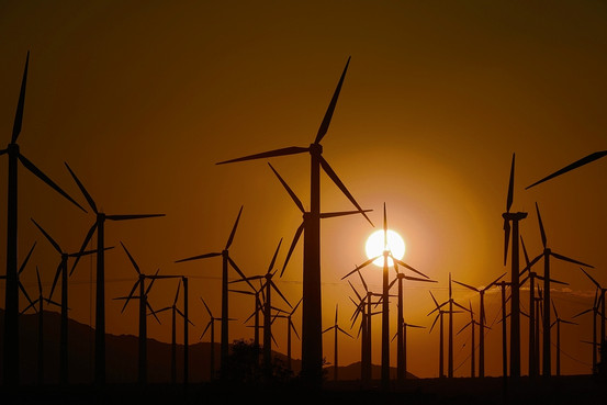 Strong winds power giant turbines in Palm Springs, Calif., on Wednesday. Mandates for utilities passed by states have fueled a big expansion of wind and solar capacity in recent years.