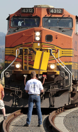 A Longshore union member blocks a grain train headed to a Longview terminal in September 2011. The long conflict between the union and operators of grain terminals at Northwest ports officially ended with ratification of a new pact.