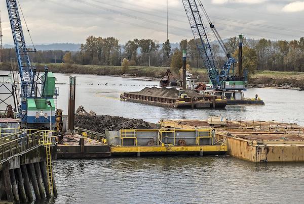 Workers clean up legacy contamination from the former Reynolds aluminum plant just off the dike at the Millennium Bulk Terminals Longview site on the Columbia River in 2016. (Bill Wagner photo, The Daily News file)