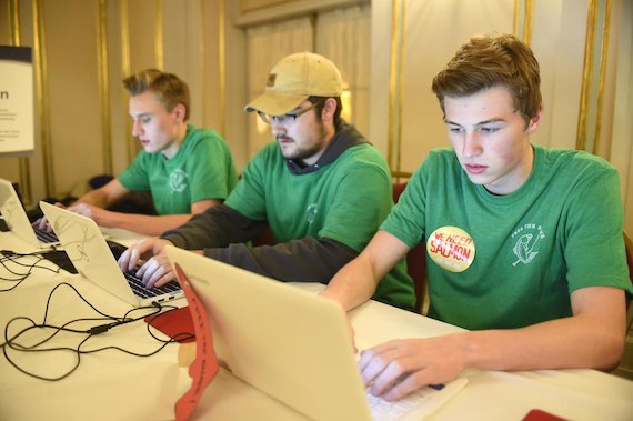 From left, Will Vogt, Zachary Utzinger and Braxton Romriell put their comments about salmon policy at a meeting about salmon policy, Monday, Nov. 14, 2016 at the Davenport Hotel. The young men took part in a rally advocating for the breaching of Snake River dams before the meeting at the Davenport. (Jesse Tinsley / The Spokesman-Review)