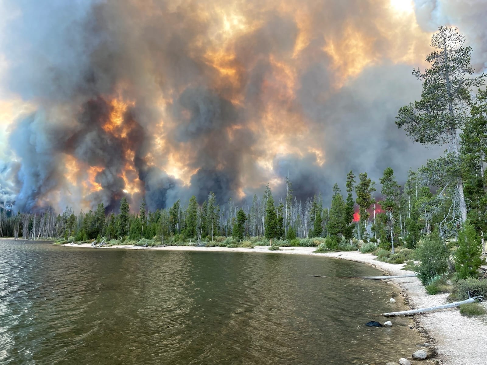 Spreading under what officials call 'extreme behavior,' the over 35,000 acre Wapiti Fire burns past a tree line near Stanley Lake, in a photo taken Aug. 22. (Courtesy of Custer County Sheriff's Office Facebook page)