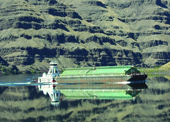 Wheat barge on the Lower Snake River, likely near the entry of Lower Granite dam's lock for transport of wheat downstream.