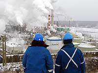 (Jeff McIntosh) The processing plant at the Suncor oil sands project in Fort McMurray, Alberta, pumps steam into the air. Canadians have found a new use for industrial carbon-dioxide emissions.