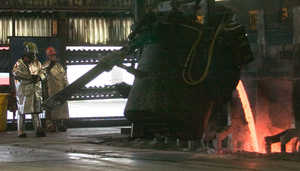 (Philip A. Dwyer) Alcoa Intalco Works aluminum smelter workers re-start a potline Monday morning by pouring a molten bath in a pot at the plant. When the restart is complete, the plant will be operating at two-thirds capacity.