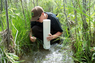 Josh Dowdy, 24, crouching in the middle of a West Foster Creek side channel, measuring pebbles.